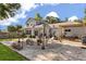 Beautifully landscaped backyard with a cozy fire pit, seating area, and lovely pavers at 32615 Windy Oak St, Sorrento, FL 32776