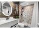 Stylish bathroom features wood accent wall, vessel sink, and a stone-tiled walk-in shower at 32615 Windy Oak St, Sorrento, FL 32776