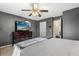 Bedroom features a TV, dresser and a gray plush blanket at 32615 Windy Oak St, Sorrento, FL 32776