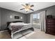 Cozy bedroom showcasing a dark gray wall, window views and a comfortable bed at 32615 Windy Oak St, Sorrento, FL 32776