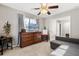 Relaxing bedroom featuring a comfortable gray sofa and a dark wood dresser at 32615 Windy Oak St, Sorrento, FL 32776