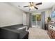 Inviting bedroom with an exterior door, gray sofa and dresser at 32615 Windy Oak St, Sorrento, FL 32776