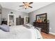 This spacious bedroom offers a ceiling fan, wood-look floors, and double dressers with mirrors at 32615 Windy Oak St, Sorrento, FL 32776