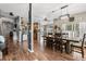 Spacious dining room open to the kitchen, featuring wood-look floors and rustic decor at 32615 Windy Oak St, Sorrento, FL 32776