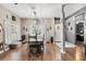 Cozy dining space with wood-look floors, rustic accents, and adjacent entryway at 32615 Windy Oak St, Sorrento, FL 32776