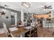 Open dining area with rustic wood table, stylish lighting, and view of the kitchen at 32615 Windy Oak St, Sorrento, FL 32776