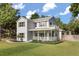 Classic two-story home with a spacious front porch and beautifully landscaped yard at 32615 Windy Oak St, Sorrento, FL 32776