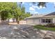 Spacious three-car garage with an expansive driveway and well-manicured lawn at 32615 Windy Oak St, Sorrento, FL 32776