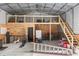 Large garage interior with a lofted area, wood accents, and abundant storage space at 32615 Windy Oak St, Sorrento, FL 32776