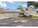 Spacious three-car garage with an expansive driveway and well-manicured lawn at 32615 Windy Oak St, Sorrento, FL 32776