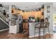 Charming kitchen featuring wooden cabinets, stainless steel appliances, and a breakfast bar with seating at 32615 Windy Oak St, Sorrento, FL 32776