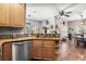 Well-lit kitchen with wooden cabinets, granite countertops, and hardwood floors at 32615 Windy Oak St, Sorrento, FL 32776