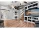 Open-concept living room featuring a fireplace, built-in shelving, and wood-look floors at 32615 Windy Oak St, Sorrento, FL 32776