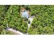 Aerial view of the home showcases the property's secluded location surrounded by mature trees and the pool at 3441 Hickory Creek Rd, Deltona, FL 32738