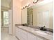 Bathroom with a double sink vanity with granite countertops and white cabinets at 3441 Hickory Creek Rd, Deltona, FL 32738