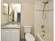 A clean bathroom with a shower-tub combo and matching sink and commode at 3441 Hickory Creek Rd, Deltona, FL 32738