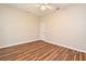 Neutral bedroom with wood-look floors, ceiling fan, and a single door at 3441 Hickory Creek Rd, Deltona, FL 32738