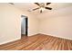 This bright bedroom has wood floors, a ceiling fan, and a neutral color scheme at 3441 Hickory Creek Rd, Deltona, FL 32738