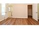A bedroom with wood floors, neutral walls, and easy access to the bathroom and walk-in closet at 3441 Hickory Creek Rd, Deltona, FL 32738