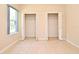 Bedroom features a window and large closets at 3441 Hickory Creek Rd, Deltona, FL 32738