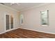 Cozy bedroom featuring hardwood floors, windows and glass paneled closet doors at 3441 Hickory Creek Rd, Deltona, FL 32738
