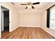 Bright bedroom features wood floors, a ceiling fan, and a closet in the doorway at 3441 Hickory Creek Rd, Deltona, FL 32738