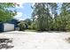 A view of the driveway leading to the home and its two-car garage, nestled among trees at 3441 Hickory Creek Rd, Deltona, FL 32738