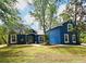Charming blue home with mature trees and landscaping at 3441 Hickory Creek Rd, Deltona, FL 32738