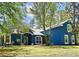 Bright blue home with a manicured front lawn and mature landscaping at 3441 Hickory Creek Rd, Deltona, FL 32738