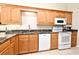 Modern kitchen featuring stainless steel appliances, custom cabinets and tile floor at 3441 Hickory Creek Rd, Deltona, FL 32738