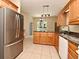 Bright kitchen with granite countertops, a center island, stainless steel fridge and tile floors at 3441 Hickory Creek Rd, Deltona, FL 32738