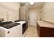 A laundry room with a washer, dryer, shelving, utility sink and countertop area at 3441 Hickory Creek Rd, Deltona, FL 32738
