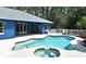 Backyard pool with house; covered patio features fans and bench seat, with views of pool, spa and patio at 3441 Hickory Creek Rd, Deltona, FL 32738