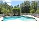 Beautiful backyard pool with an arbor, surrounding fence, mature trees and lush landscaping create a private oasis at 3441 Hickory Creek Rd, Deltona, FL 32738