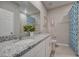 Bathroom featuring a double vanity with granite countertops and a decorative blue shower curtain at 3586 Dahlia Dr, Lake Hamilton, FL 33851