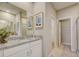 Bright bathroom showcasing granite countertops, dual sinks, a large mirror, and glass enclosed shower at 3586 Dahlia Dr, Lake Hamilton, FL 33851