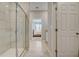 Modern bathroom featuring glass shower and view into bedroom with a large window at 3586 Dahlia Dr, Lake Hamilton, FL 33851