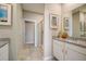 Well-lit bathroom with granite countertops, framed abstract art and a glass-enclosed shower with tiled floors at 3586 Dahlia Dr, Lake Hamilton, FL 33851