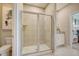 Bathroom featuring a modern glass-enclosed shower, a toilet, and a vanity next to a bedroom at 3586 Dahlia Dr, Lake Hamilton, FL 33851