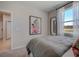 Bright bedroom with a comfortable bed, a side door entrance, and a view of the outdoors at 3586 Dahlia Dr, Lake Hamilton, FL 33851