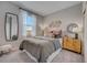 Bright bedroom with window, stylish furniture, and modern décor with decorative mirror at 3586 Dahlia Dr, Lake Hamilton, FL 33851