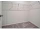 Empty walk-in closet featuring gray carpeting, wire shelving, and crisp white walls at 3586 Dahlia Dr, Lake Hamilton, FL 33851