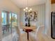 Charming dining area with modern chandelier and view of the outdoor patio at 3586 Dahlia Dr, Lake Hamilton, FL 33851