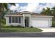 Charming single-story home with well-manicured lawn and attached two-car garage at 3586 Dahlia Dr, Lake Hamilton, FL 33851