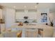Bright kitchen featuring white cabinets, stainless steel appliances and a granite countertop island at 3586 Dahlia Dr, Lake Hamilton, FL 33851