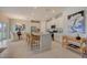 Modern kitchen with white cabinets, island seating, and open view to the dining area at 3586 Dahlia Dr, Lake Hamilton, FL 33851