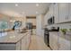 Gourmet kitchen featuring white cabinets, granite countertops and stainless steel appliances at 3586 Dahlia Dr, Lake Hamilton, FL 33851