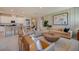 Open-concept living room with stylish furniture, wood accents, and seamless kitchen access at 3586 Dahlia Dr, Lake Hamilton, FL 33851