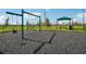 Swingset at the playground, set in a fenced area with a bench, picnic table and shaded table nearby at 3586 Dahlia Dr, Lake Hamilton, FL 33851
