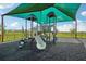 Covered community playground with a variety of slides and interactive features for children, offering fun in a safe setting at 3586 Dahlia Dr, Lake Hamilton, FL 33851